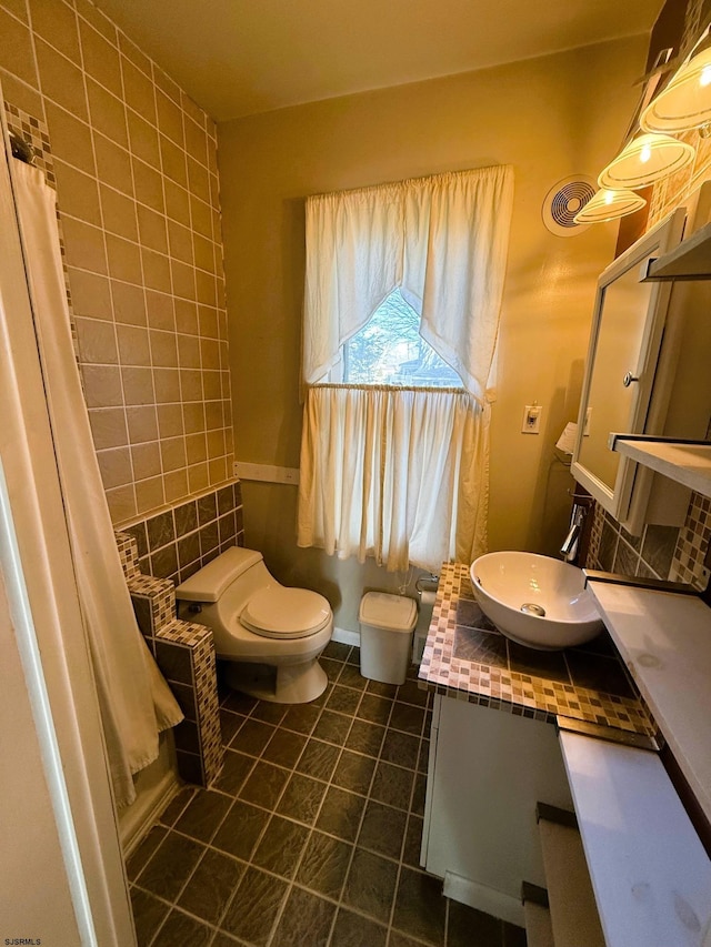 bathroom with vanity, curtained shower, tile patterned floors, and toilet