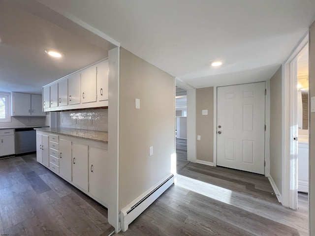 kitchen with dishwasher, hardwood / wood-style floors, white cabinets, and baseboard heating