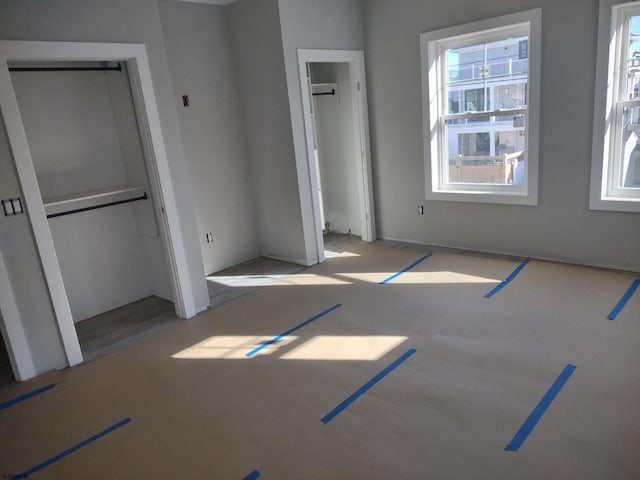 unfurnished bedroom with multiple windows