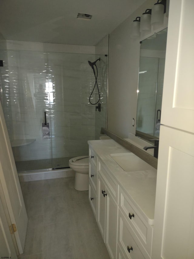 bathroom with vanity, an enclosed shower, and toilet