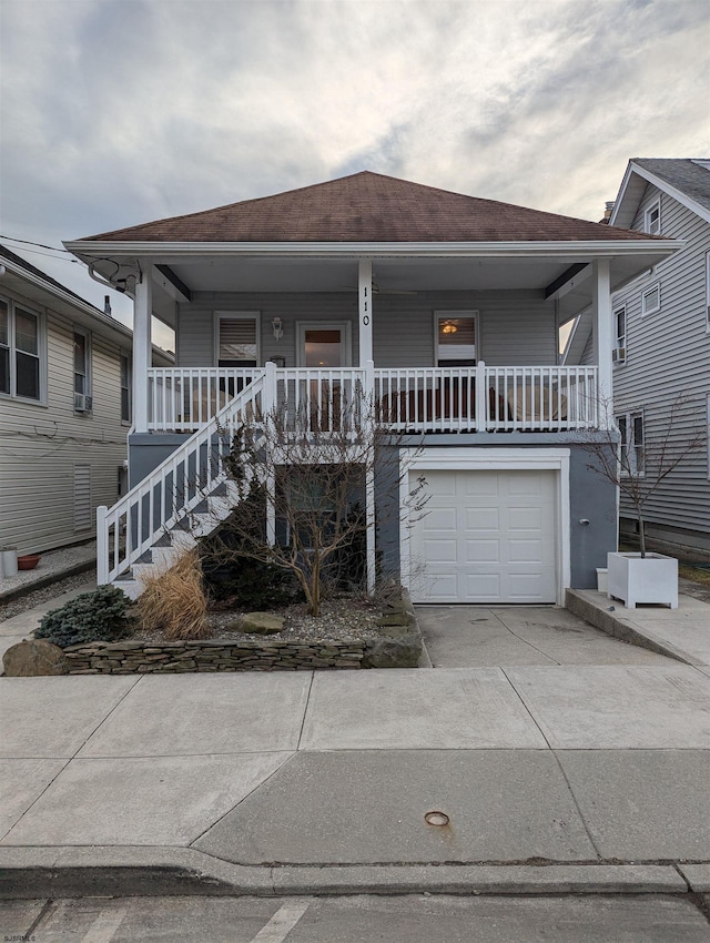 view of front of property with a garage and covered porch