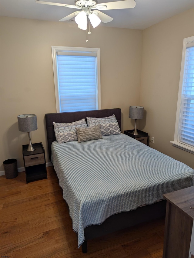 bedroom featuring ceiling fan and dark hardwood / wood-style flooring