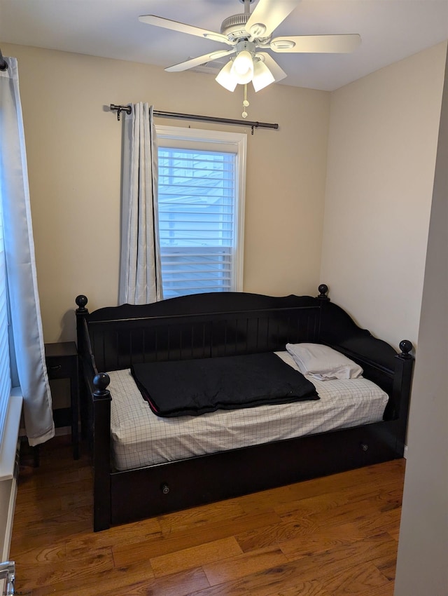 bedroom with hardwood / wood-style flooring and ceiling fan