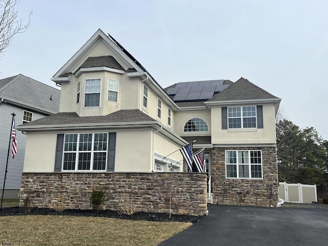 view of front facade with solar panels