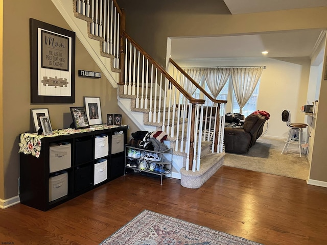 stairs featuring ornamental molding and wood-type flooring