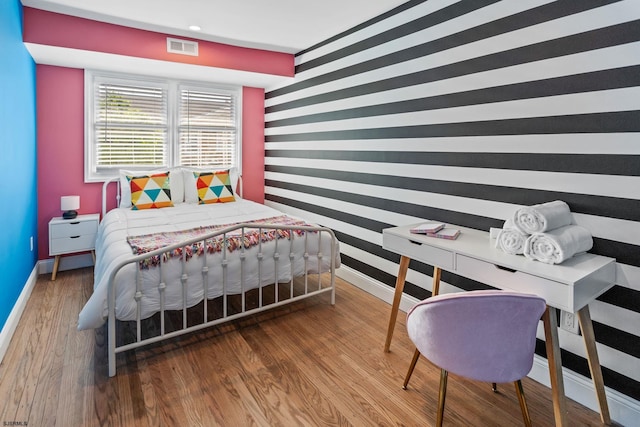 bedroom with wood-type flooring