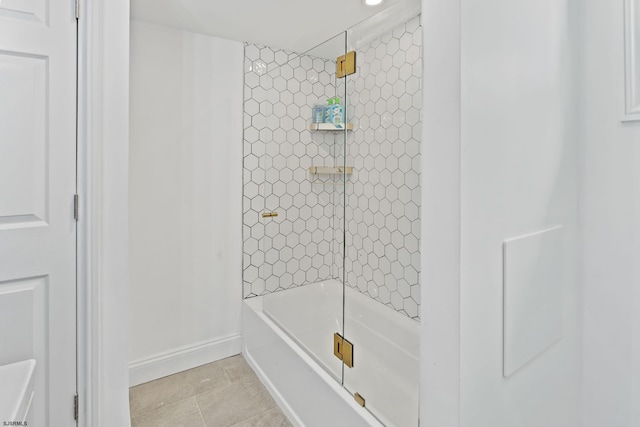 bathroom with tiled shower / bath combo and tile patterned floors