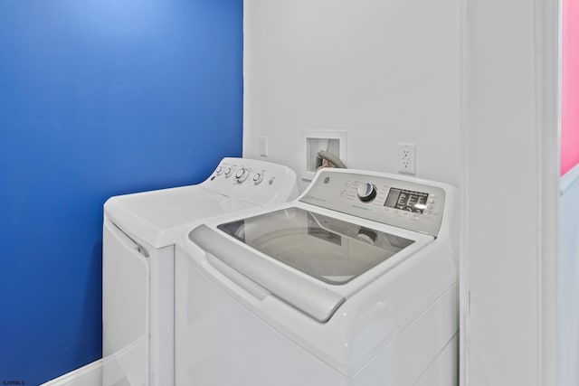 clothes washing area with washing machine and clothes dryer