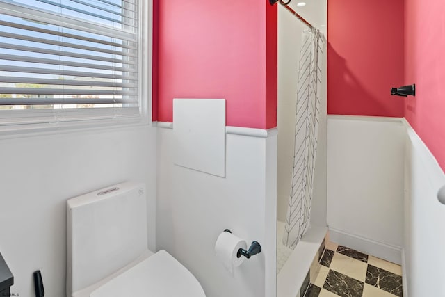 bathroom with toilet and curtained shower