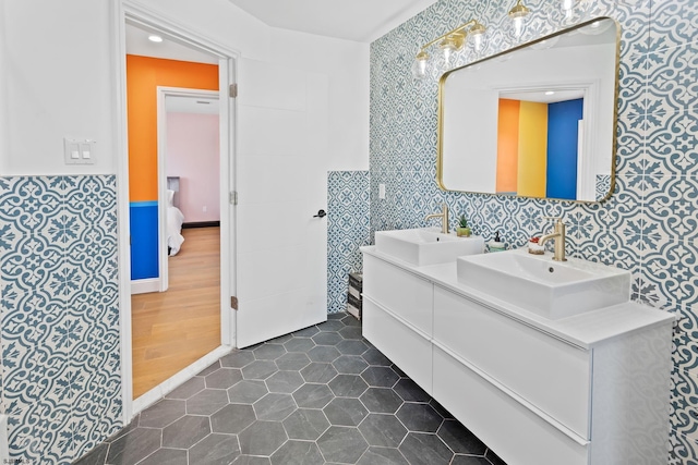 bathroom with vanity, toilet, tile patterned flooring, and tile walls