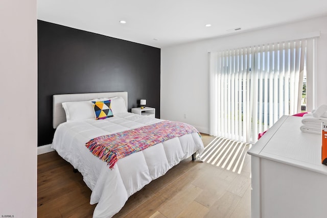 bedroom with hardwood / wood-style floors