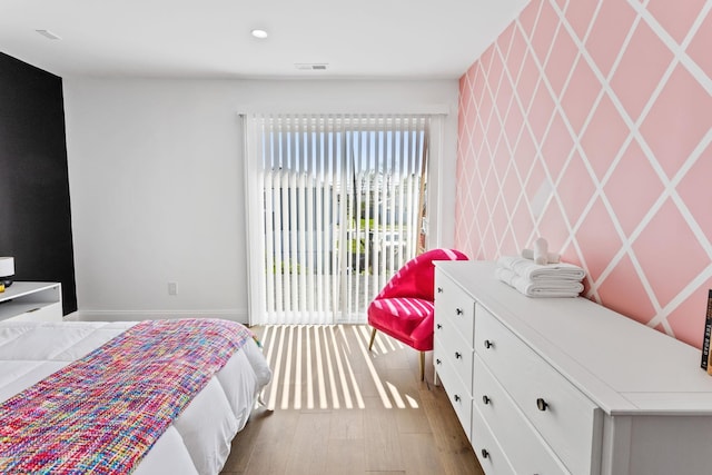 bedroom featuring access to exterior and light hardwood / wood-style floors