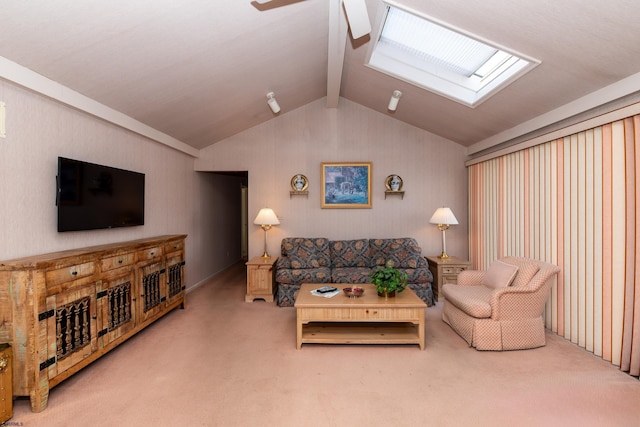 carpeted living room featuring lofted ceiling with skylight and ceiling fan