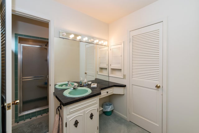 bathroom with vanity and an enclosed shower