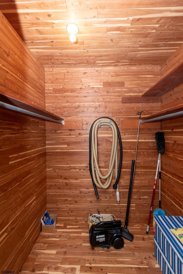 interior space featuring wood ceiling, hardwood / wood-style flooring, and wood walls