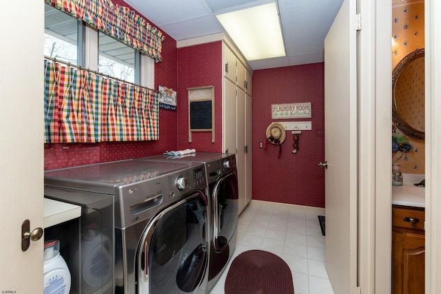 laundry room with washer and clothes dryer and light tile patterned flooring