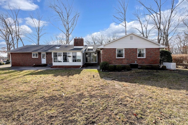 view of front of property with a front lawn and a sunroom