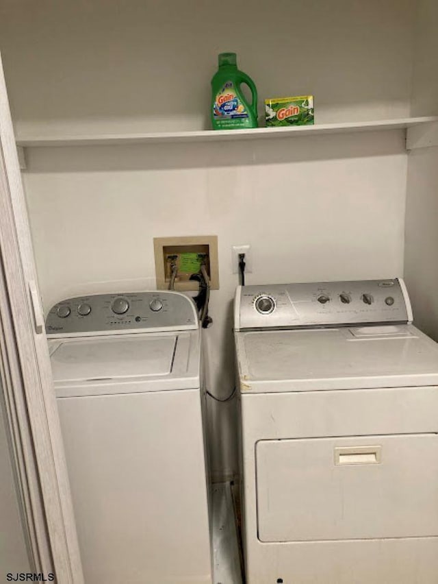 clothes washing area with separate washer and dryer