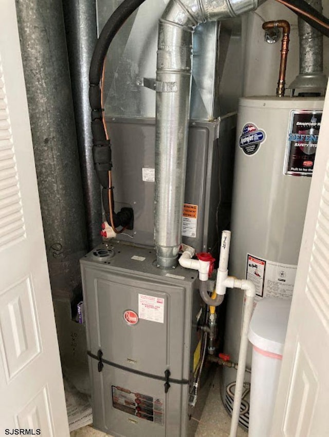 utility room featuring heating unit and water heater