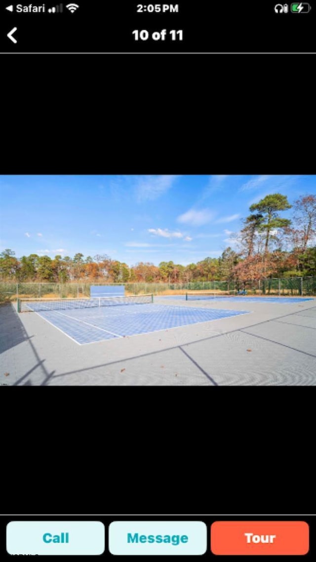 view of swimming pool with tennis court