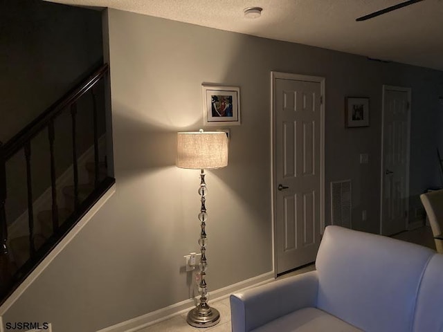 living area with a textured ceiling