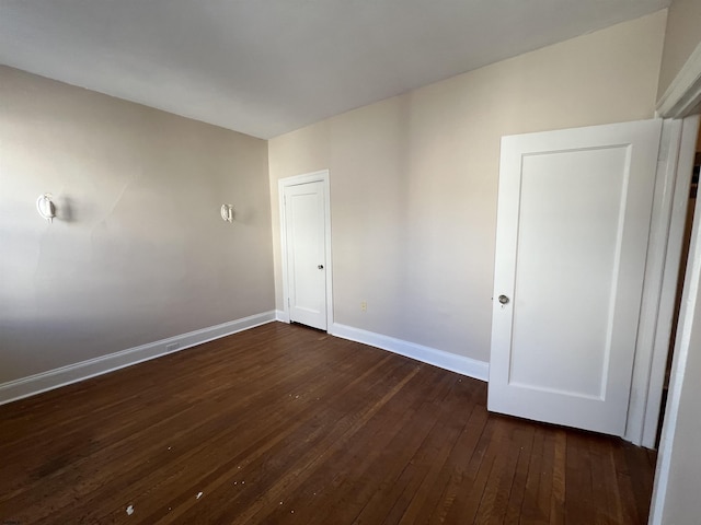 spare room featuring dark hardwood / wood-style flooring