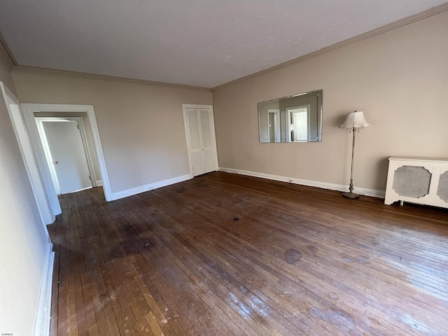 unfurnished bedroom featuring crown molding and wood-type flooring