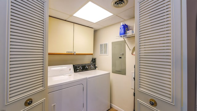 laundry area featuring cabinets, electric panel, and washer and clothes dryer