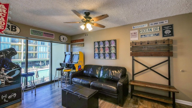 living room with ceiling fan, hardwood / wood-style floors, and a textured ceiling