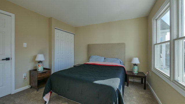 carpeted bedroom with multiple windows and a closet