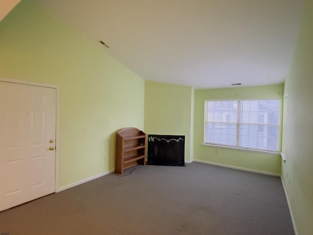 unfurnished living room featuring dark carpet