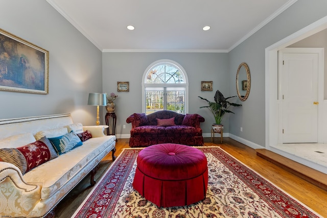 living room with hardwood / wood-style flooring and ornamental molding