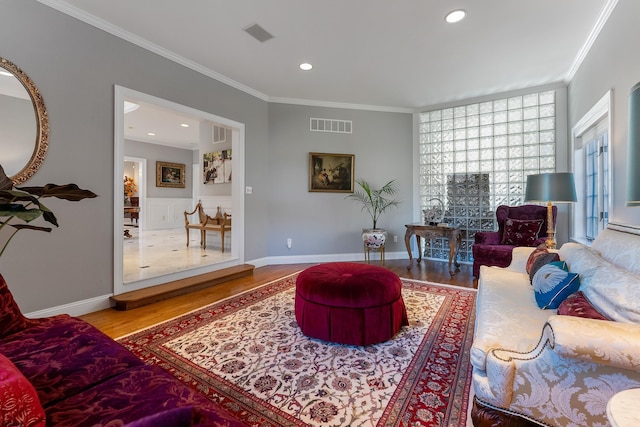 living room featuring hardwood / wood-style floors and crown molding