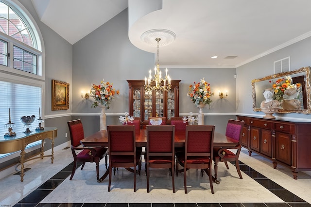 dining space with ornamental molding, high vaulted ceiling, and a notable chandelier