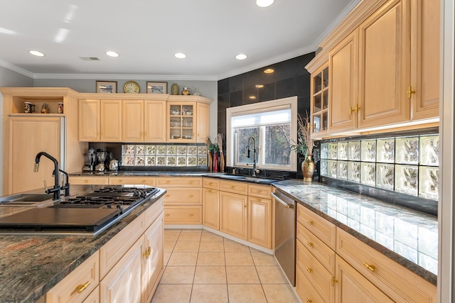 kitchen with light brown cabinetry, sink, light tile patterned floors, dark stone countertops, and stainless steel dishwasher