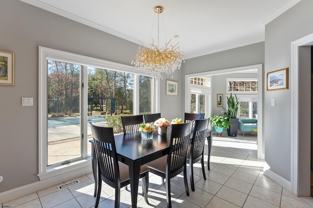 tiled dining space with a notable chandelier, plenty of natural light, and ornamental molding