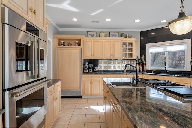 kitchen with pendant lighting, sink, light tile patterned floors, decorative backsplash, and stainless steel double oven