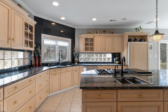 kitchen with pendant lighting, sink, a center island with sink, light brown cabinetry, and stainless steel dishwasher