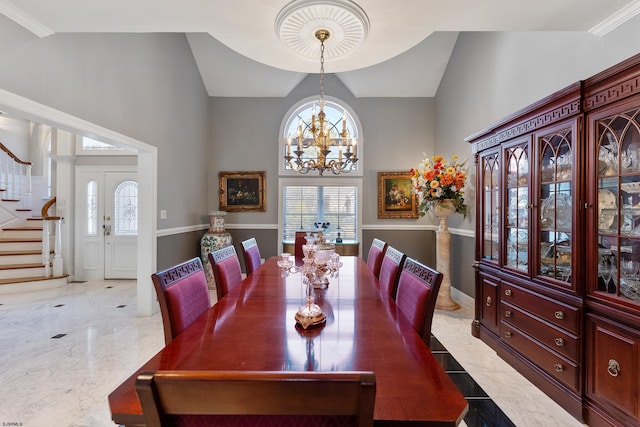 dining room with an inviting chandelier and vaulted ceiling