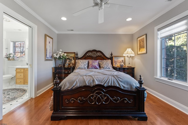 bedroom with multiple windows, hardwood / wood-style floors, connected bathroom, and ornamental molding