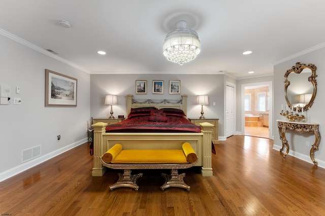 bedroom featuring a notable chandelier, wood-type flooring, and ornamental molding