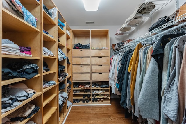 spacious closet featuring hardwood / wood-style floors