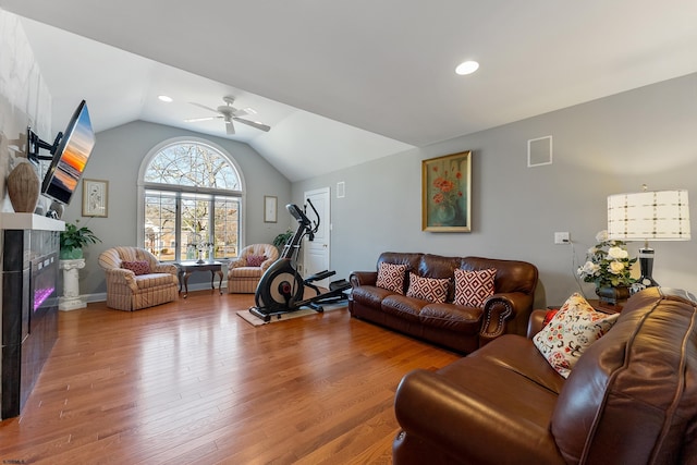 living room with vaulted ceiling, hardwood / wood-style floors, and ceiling fan