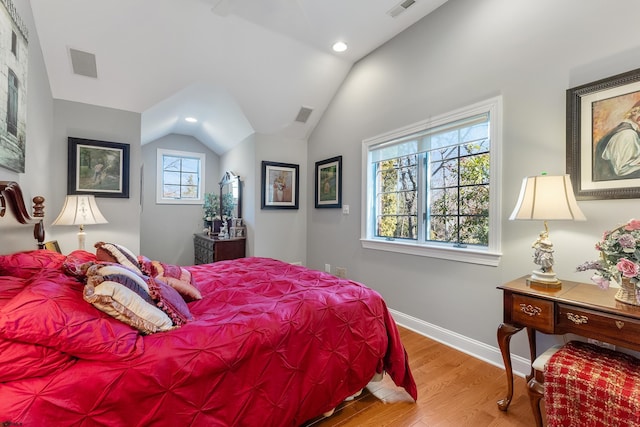 bedroom with hardwood / wood-style flooring and vaulted ceiling