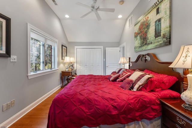 bedroom featuring ceiling fan, vaulted ceiling, a closet, and wood-type flooring