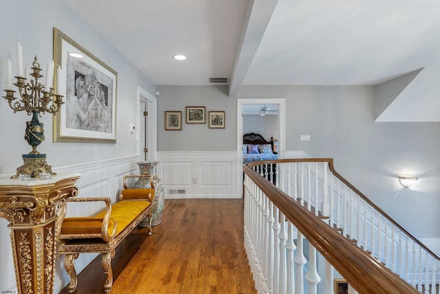 hall featuring beam ceiling and hardwood / wood-style flooring