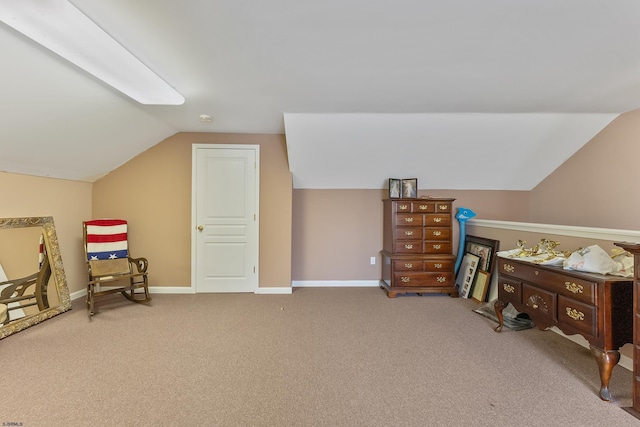 interior space with vaulted ceiling and carpet floors