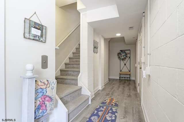 stairs featuring hardwood / wood-style floors