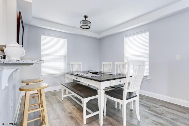 dining space with hardwood / wood-style floors