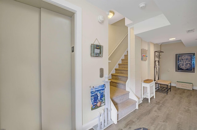 staircase with wood-type flooring